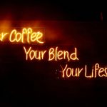 Glowing neon sign saying 'Your Coffee, Your Blend, Your Lifestyle' in warm tones, perfect for cafes.