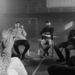 A black and white image of a support group engaged in a therapy session.